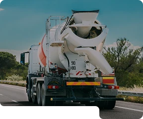 A cement truck driving down the road
