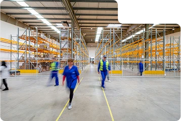 Warehouse workers walking around a warehouse